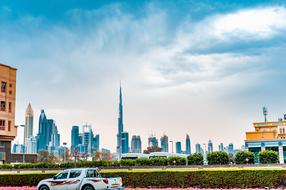 car parked against the backdrop of the Burj Khalifa tower in Dubai