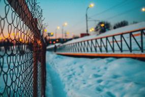 Person, on the beautiful, snowy road with lights, at colorful sunset, in winter