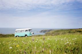vintage Volkswagen bus on scenic seaside at summer