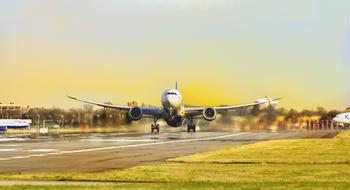 airplane on the runway against the yellow sky