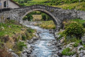 photo of a stone bridge over the river in Val d'Aran, Spain