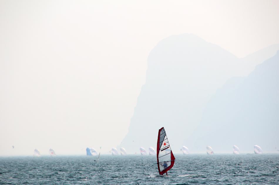sailboats on lake garda in fog