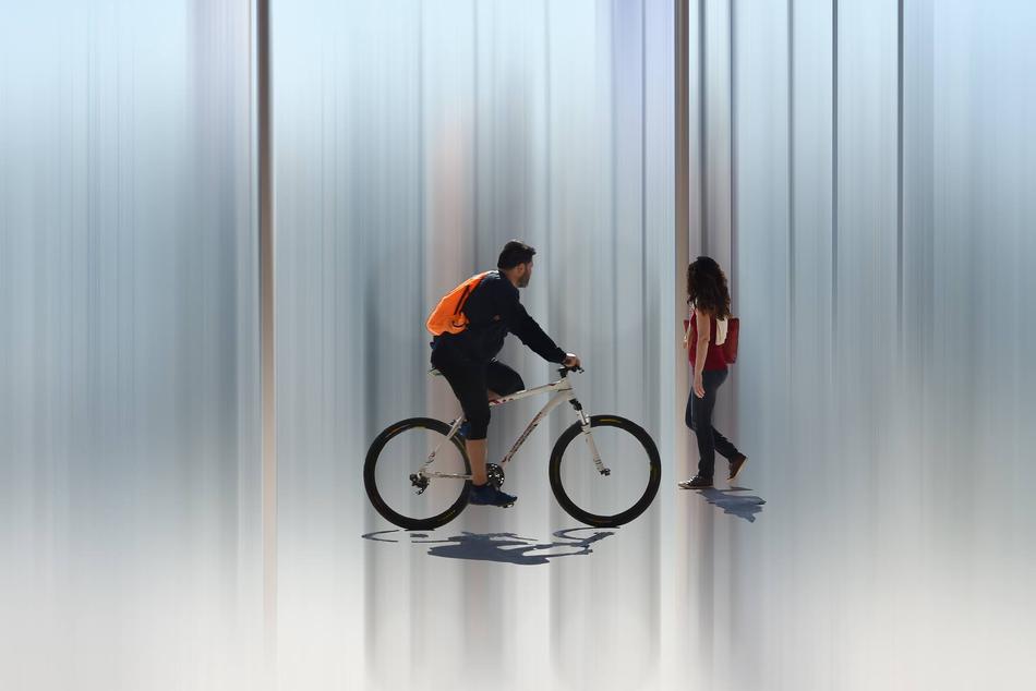 Man, riding on the bike, near the woman, clipart
