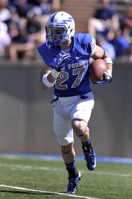 American football player with ball on blurred background