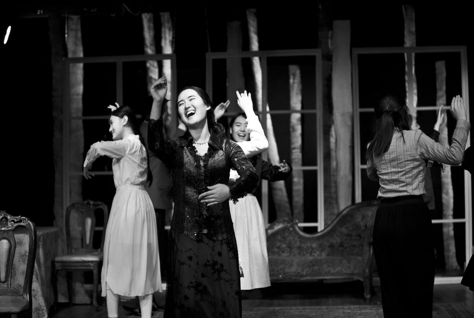 monochrome, people dancing on the stage of the theater