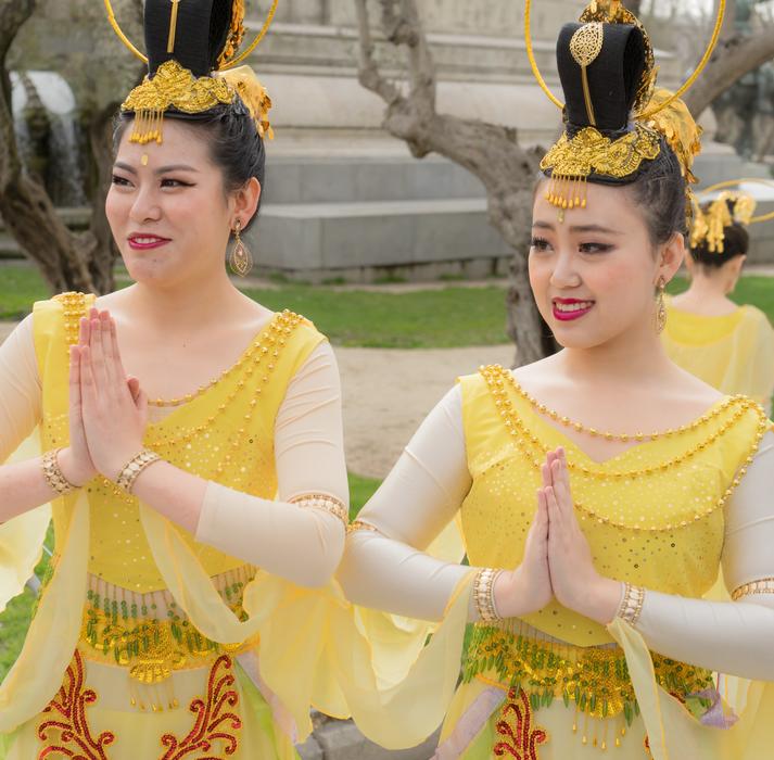 a couple of girls in yellow costumes dancing in shanghai