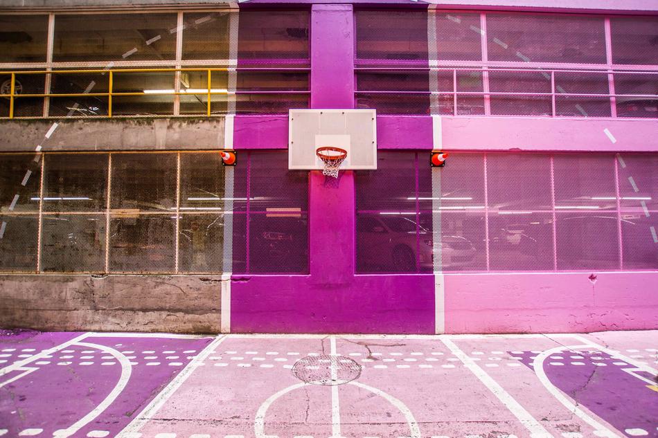 Beautiful and colorful basketball court with the hoop on the building