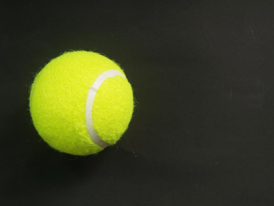 tennis ball on black background