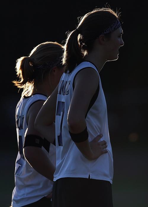 female athletes in uniform at sunset