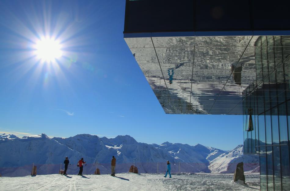Sun shining over cable car station in mountains