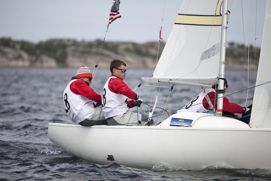 Sailboat Racing team holding ropes