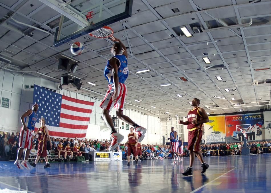 Performance of the Harlem Globetrotters, on the shiny court, with the spectators