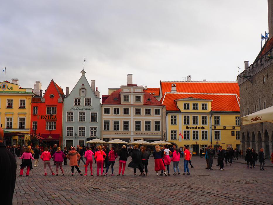 people perform in the square near the market