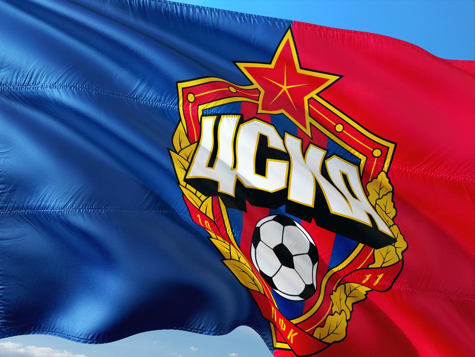 Colorful logo of Cska Moscow, on the blue and red flag, at blue sky on background