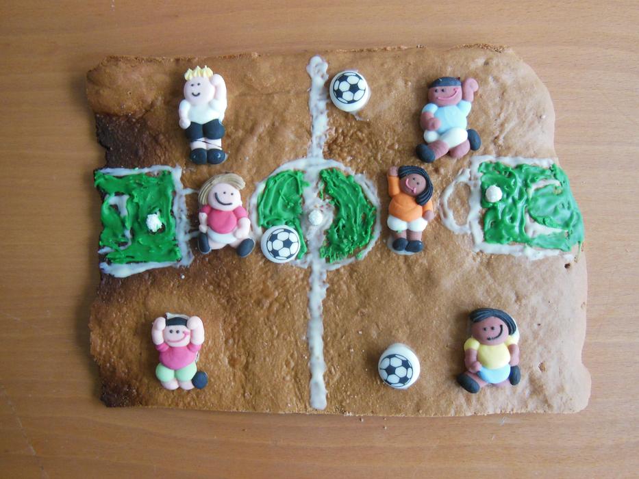 Beautiful and colorful biscuit with the players and balls on the field