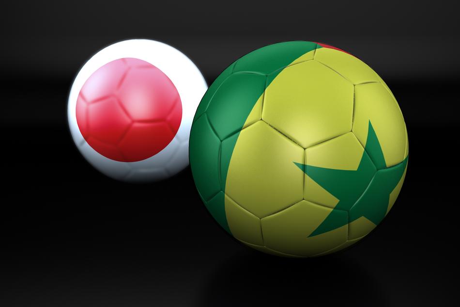 Colorful, shiny football balls with the flags of Senegal and Japan, at black background, clipart