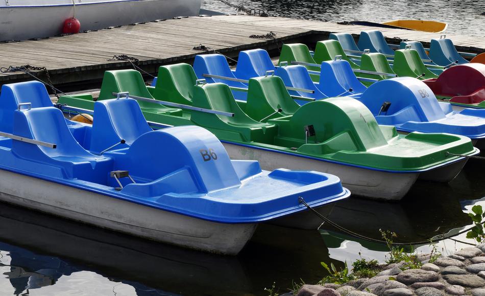 Blue and green pedal boats on the water in Trakai, Lithuania