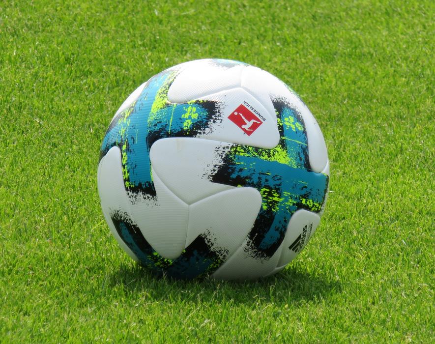 Colorful and beautiful football of Bundesliga with shadow, on the green grass