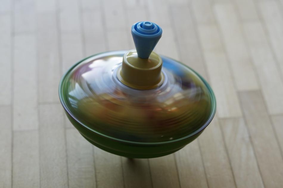 Beautiful and colorful, dancing roundabout, in motion, on the wooden surface