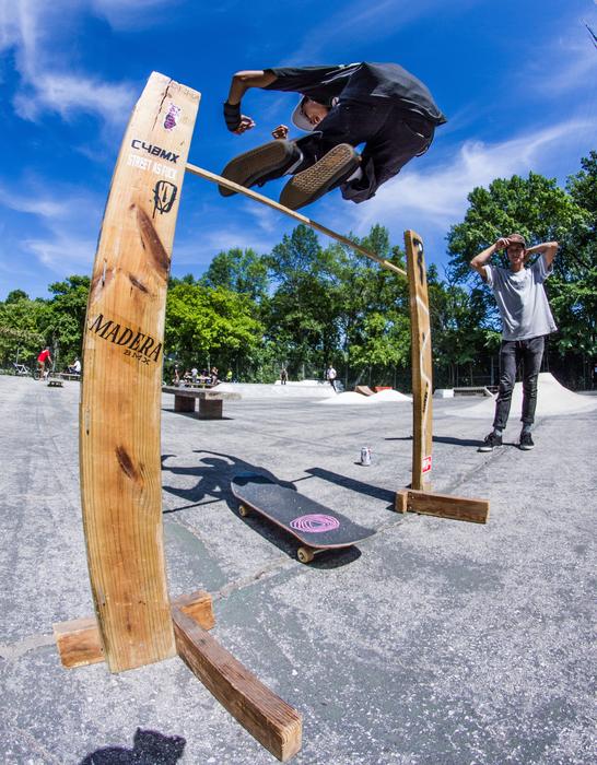 Person, doing trick in the beautiful skatepark with green trees