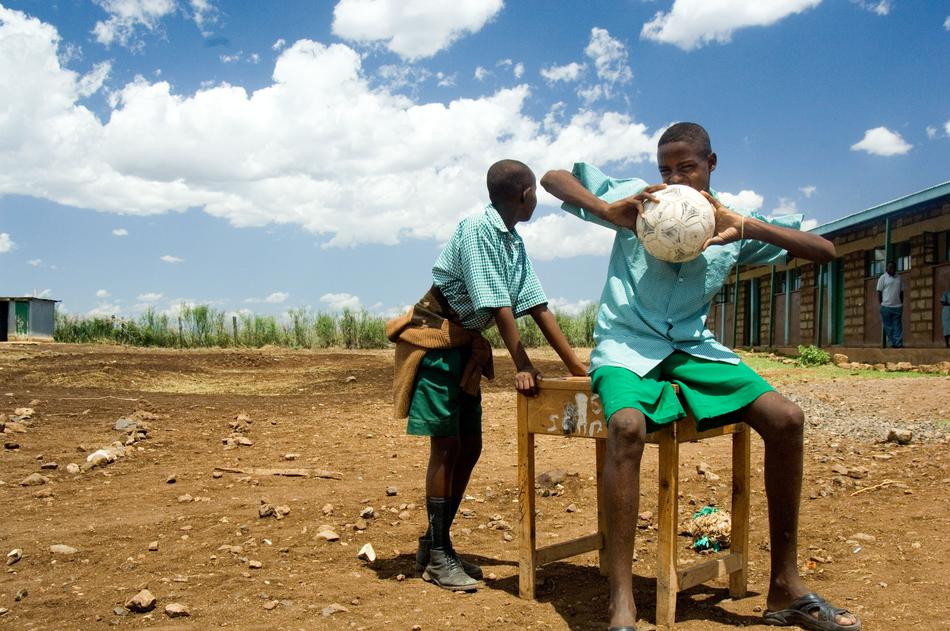 boys with a ball in the countryside in kenya