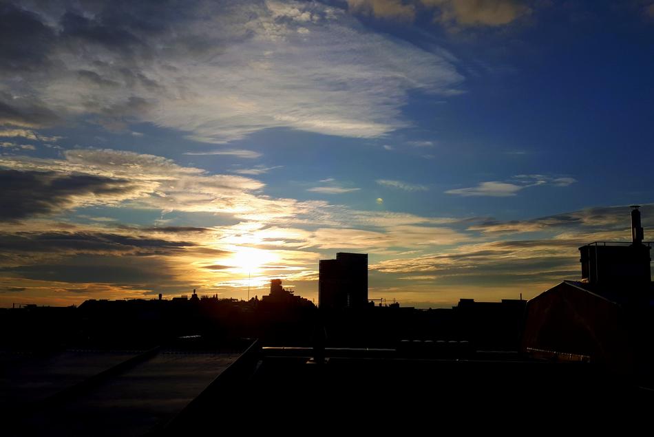 Beautiful landscape with the silhouettes of the buildings in Vienna, Austria, at beautiful and colorful sunrise, among the clouds