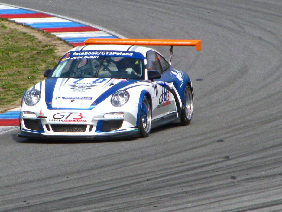 sports car racing on the track on a sunny day