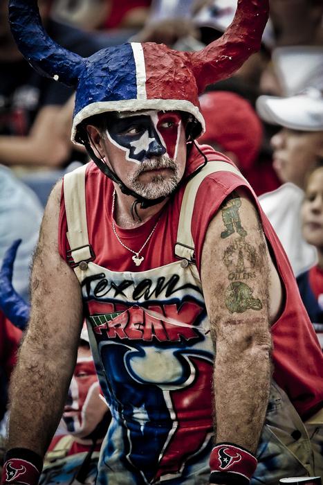 American football fan in blue, red and white clothing and paint, in Texas, America