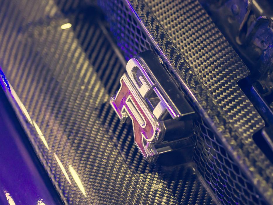 Close-up of the beautiful 'GTR' logo of the colorful, shiny car