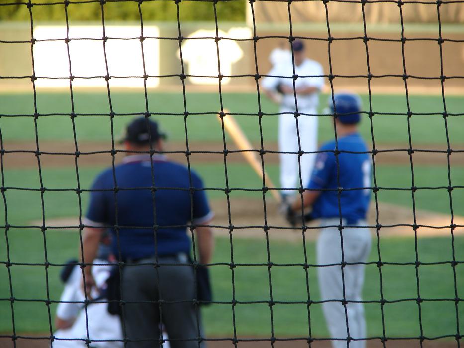 baseball players near the gate on a blurred background