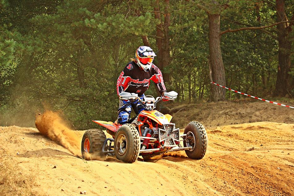 Motorsport, man riding Quad on soil road