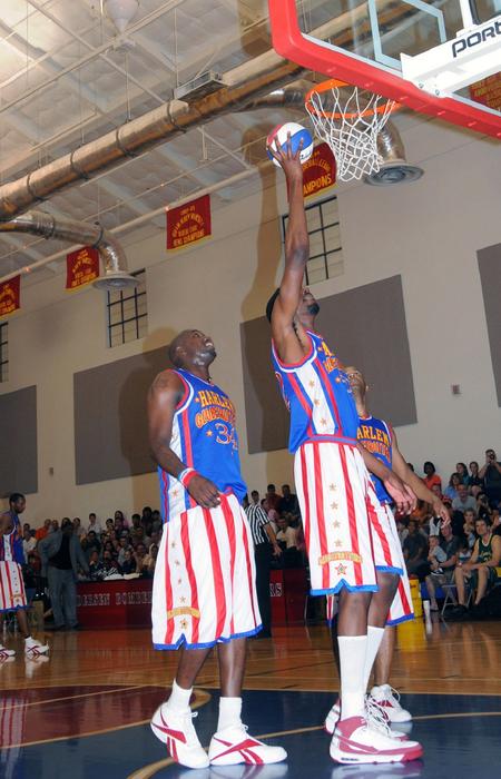 Harlem Globetrotters in colorful uniform, playing on the court, on the competition