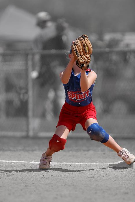 Softball female player, on the field with fence in black and white colors
