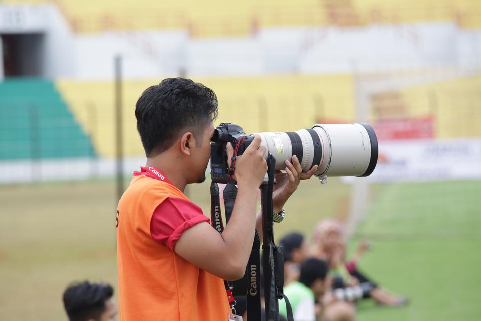 Photographer Lens Nikon on sports field
