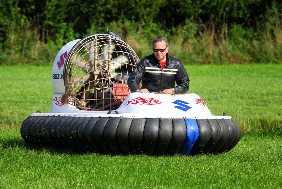 Man in gasses driving hovercraft among the plants