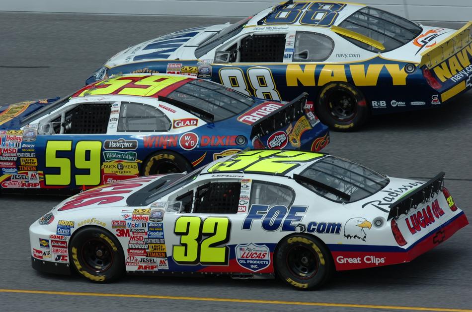 racing cars with logos and numbers during the race