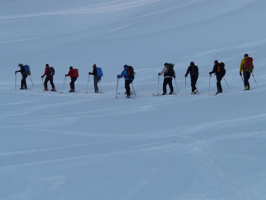 winter hike of tourists in the mountains during snowfall