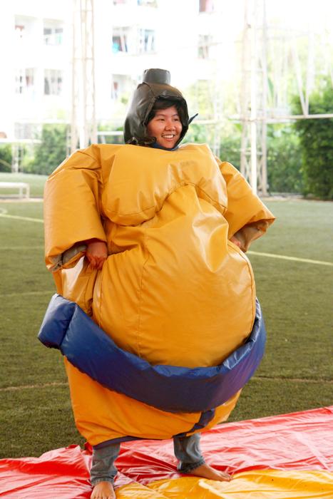 man in a sumo costume at a party