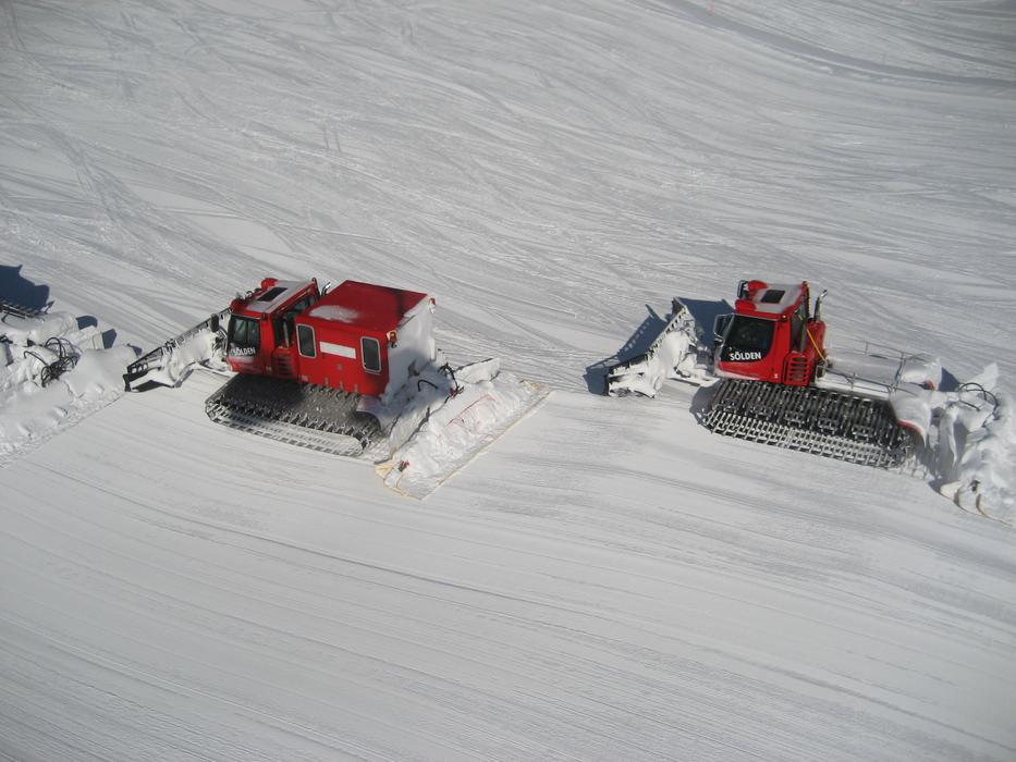 Snow groomer machines on the snowy hill