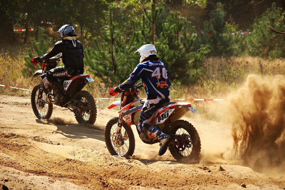 motorcycle riders in the dust on a sunny day