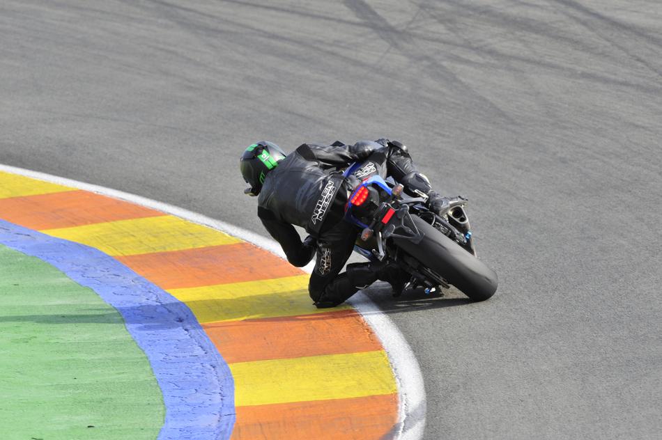 a man on a motorcycle on a race track