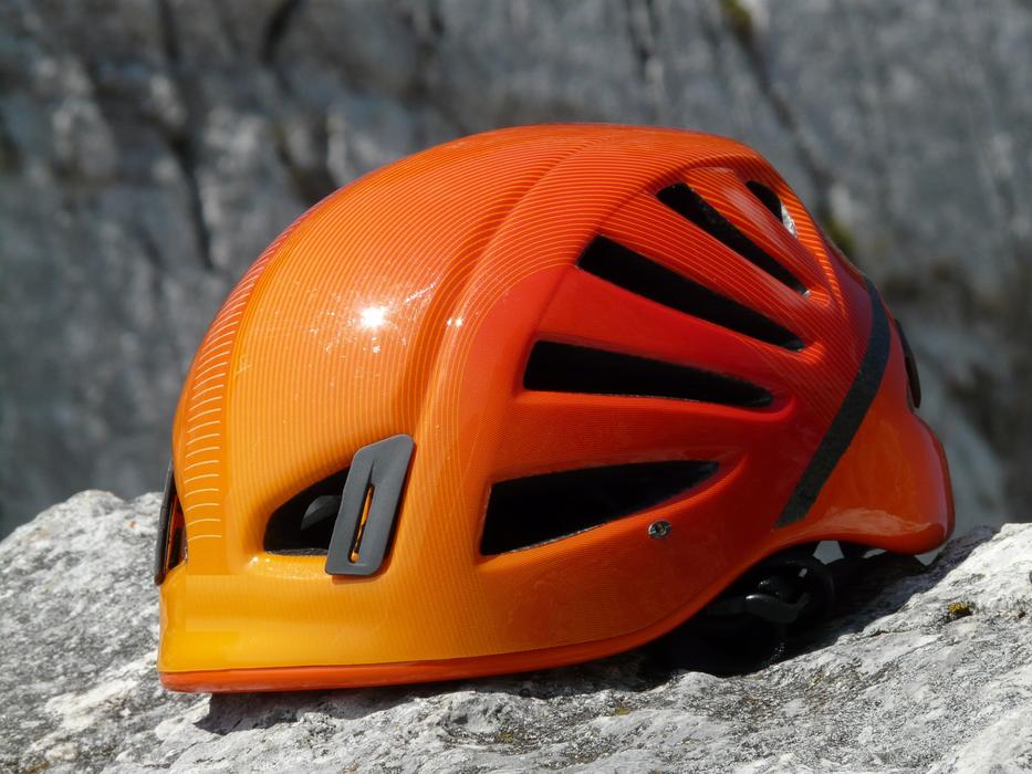 Climbing Helmet on the stones close-up on a blurred background