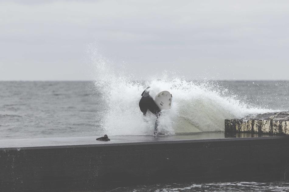 black and white, surfer hit the ocean wall