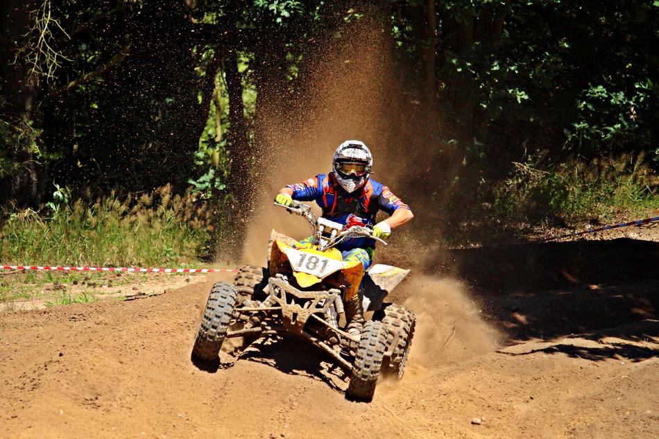 ATV rides on a country road during a race