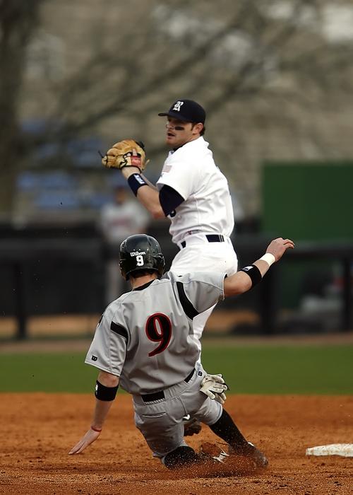 baseball player stops in front of the base