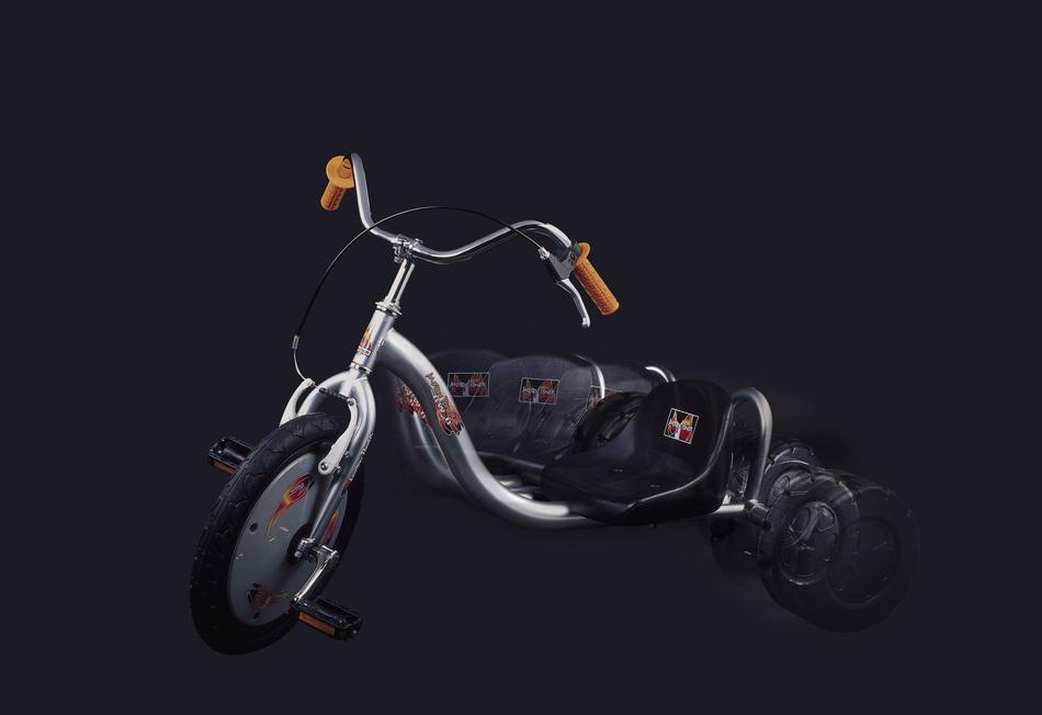 sports tricycle on black background