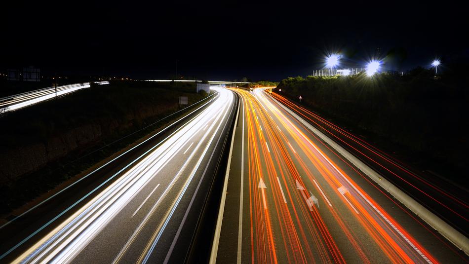 streaking car lights on road at darkness