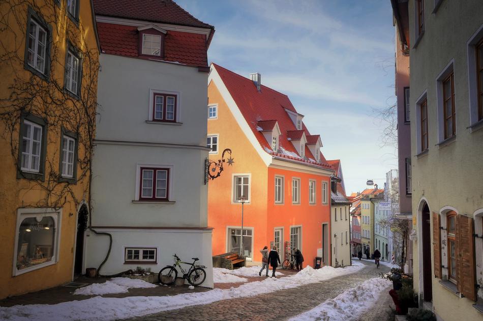 Beautiful mountain road, among the colorful houses in Landsberg in snow, in Germany