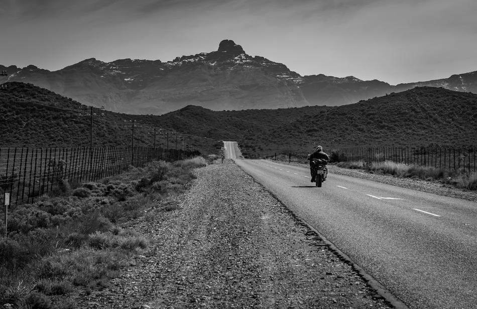 motorcyclist on the road in black and white background