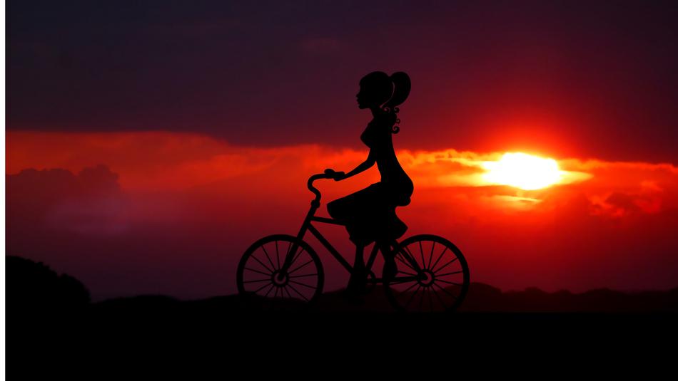 Silhouette of the girl on the bike, on the promenade, at colorful and beautiful sunrise, on the mountains, clipart
